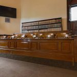 Empty courtroom with a jury box and bookshelves