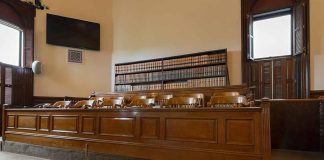 Empty courtroom with a jury box and bookshelves