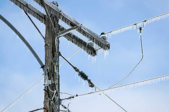 Icicles hanging from power lines and pole.