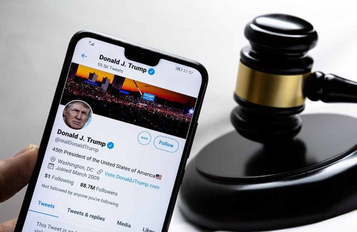 Smartphone displaying Twitter profile beside a judge’s gavel.