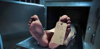 Feet with tag on mortuary slab