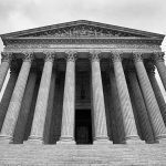 SCOTUS building with large columns and stairs.