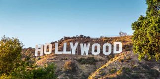 Hollywood sign on a hill with trees.