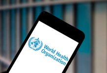 Smartphone displaying World Health Organization logo background