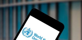 Smartphone displaying World Health Organization logo background