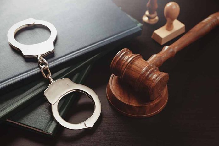 Gavel, handcuffs, and books on a table.