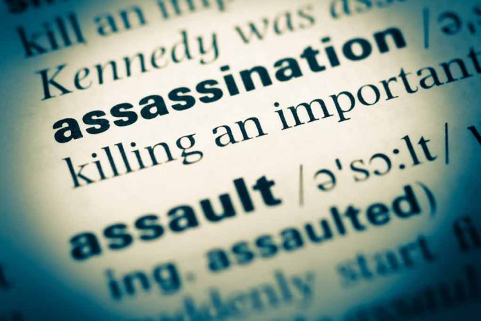 Close-up of dictionary page defining "assassination."