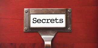 Label holder with the word "Secrets" on red background.