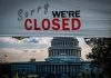 Capitol building with closed sign above entry gate