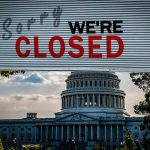 Capitol building with closed sign above entry gate