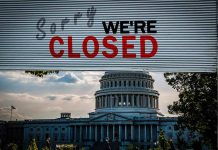 Capitol building with closed sign above entry gate