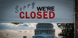 Capitol building with closed sign above entry gate