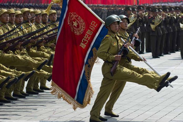 Soldiers marching with rifles and a red flag