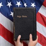 Bible held in front of American flag.