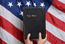 Bible held in front of American flag.