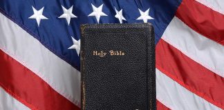 Bible held in front of American flag.