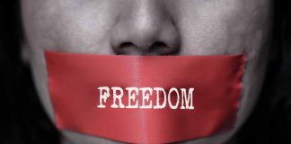 Red tape over mouth with "FREEDOM" text.