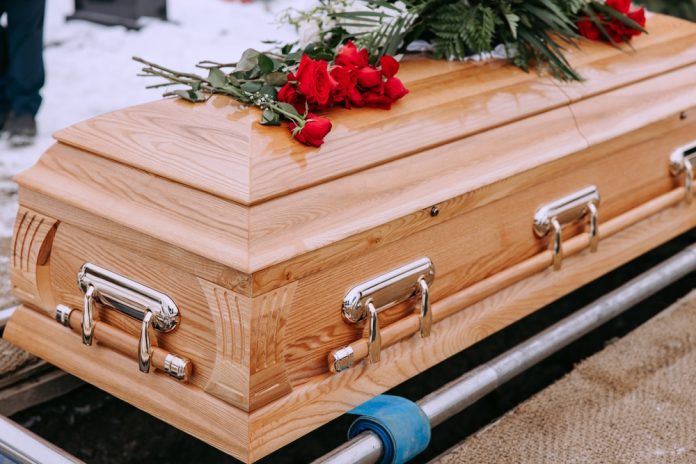 2423034429 featured image Wooden casket with red roses on top