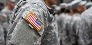 People in camouflage uniforms with US flag patch