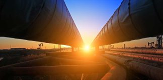 Sunset between two large industrial pipelines outdoors