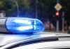 Blue police siren light flashing on vehicle roof