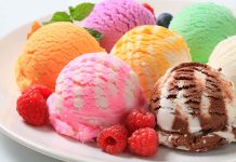 Assorted ice cream scoops with raspberries on a plate