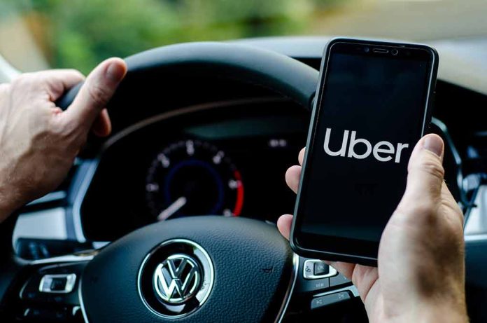 1497227390 featured image Person holding phone with Uber app inside car