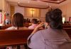 People sitting in church pews during service