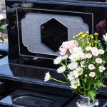 Colorful flowers on a black tombstone