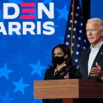 Two people speaking at a Biden Harris event