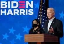 Two people speaking at a Biden Harris event