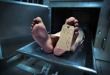Feet with tag on mortuary slab
