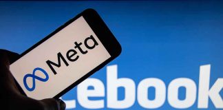 Meta logo on phone, Facebook background display.