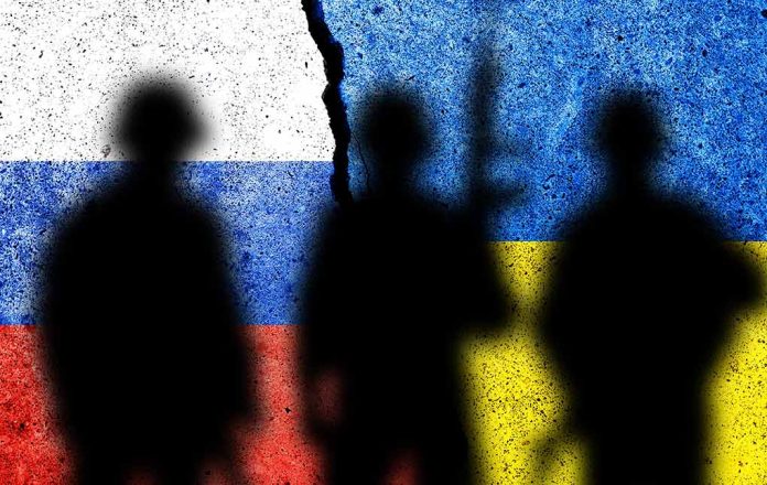 Silhouettes against split Russian and Ukrainian flags