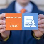 Hands holding deportation order block tiles