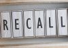 The word RECALL on wooden tiles