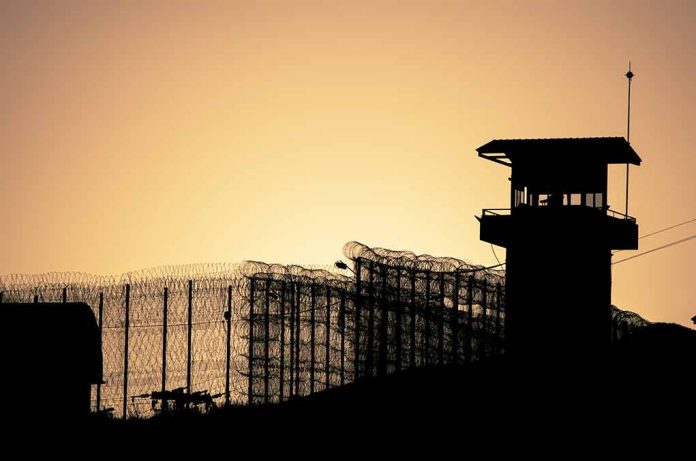 442645978 featured image Sunset behind prison fence and guard tower