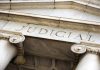 Marble columns with the word Judicial engraved above