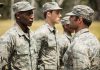 Military personnel standing in line outside during inspection