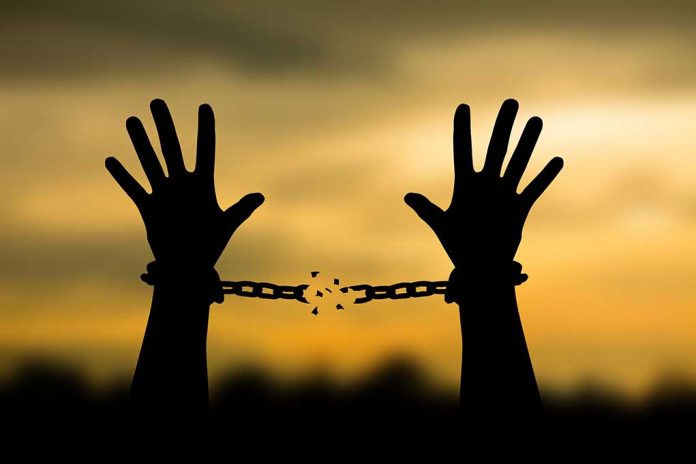 698153707 featured image Hands breaking free from chains at sunset