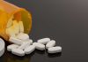 Spilled prescription bottle with white pills