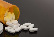 Spilled prescription bottle with white pills