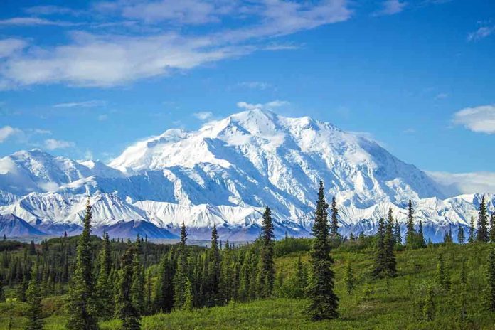 1068590996 featured image Snow covered mountain under blue sky with green foreground