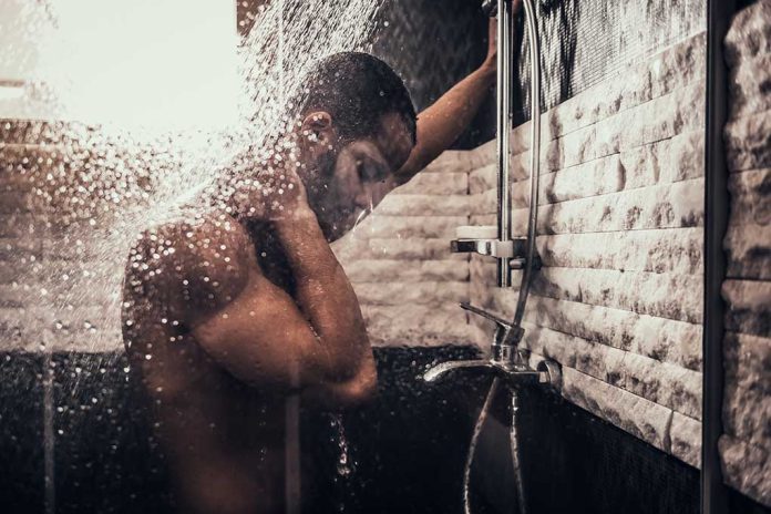 1130216810 featured image Person standing under flowing shower water indoors