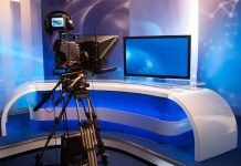 TV studio with camera and empty anchor desk