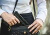 Person placing gun into a handbag