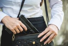 Person placing gun into a handbag