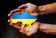 Hands holding Ukraine map with flag design