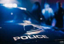 Police car with blurred figures in the background