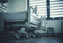 Empty hospital beds by a window